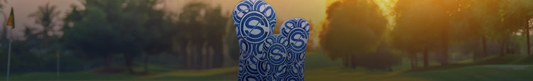 Blue and white patterned golf headcovers on a golf course at sunset, Winston Collection